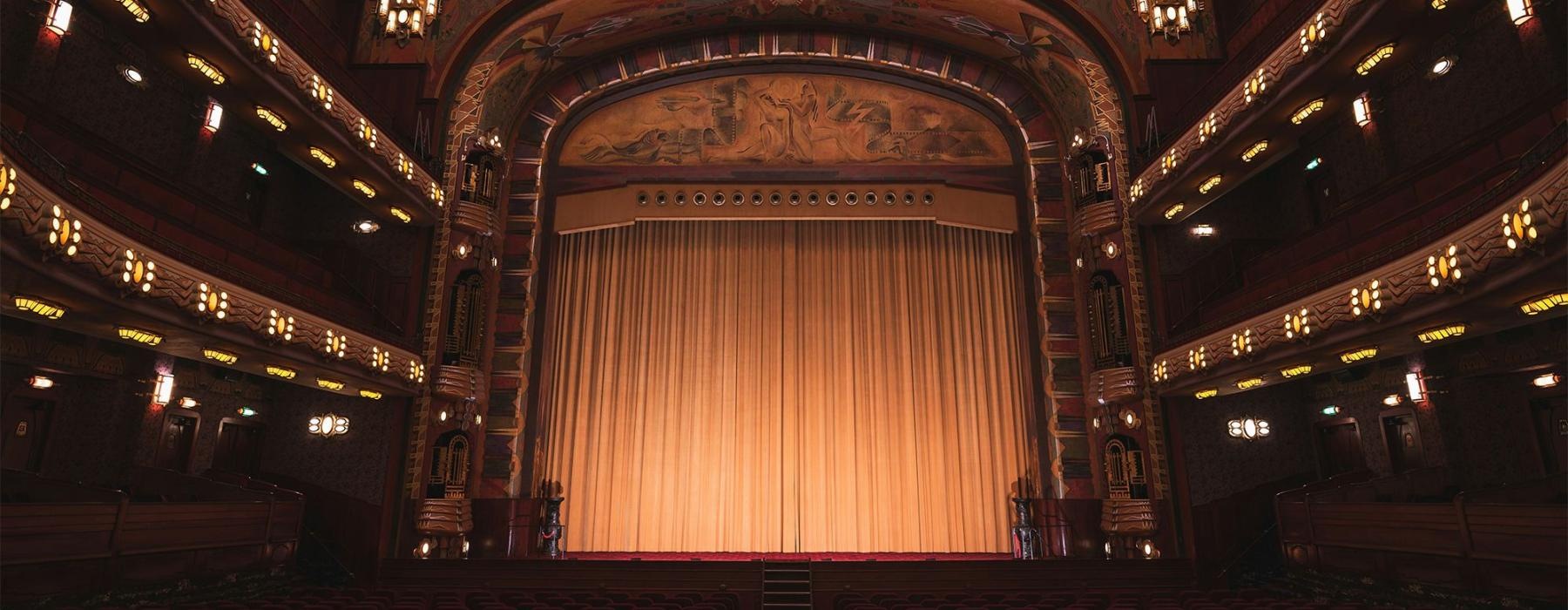 a theater with a stage and chairs